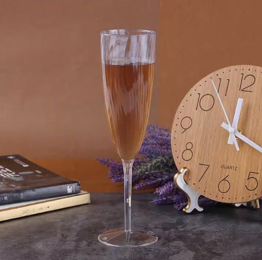 Close-up of Tang's Plastic Supply's 5oz disposable champagne glass, highlighting its clear plastic design and elegant stem.